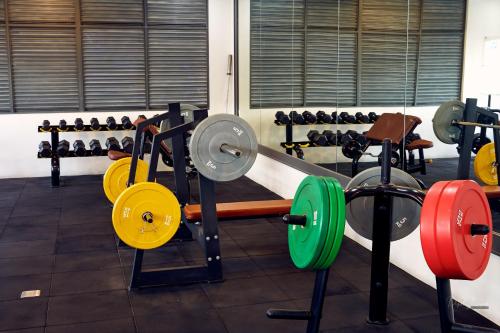 a gym with lots of different types of weights at R2N Cosy Haven - BE Residences Lahug near IT Park Cebu in Cebu City