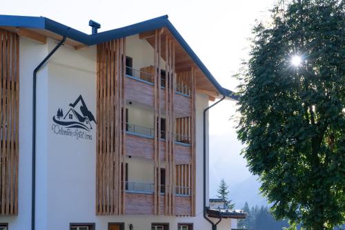 a building with a sign on the side of it at Dolomiten Hotel Irma in Canazei