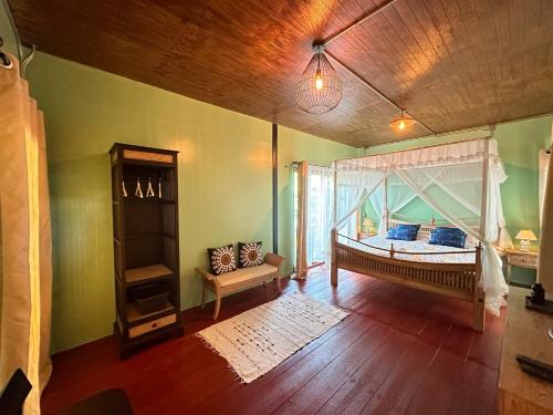 a bedroom with a bed with a canopy at SukhothaiNeeDee FarmCafe in Sukhothai