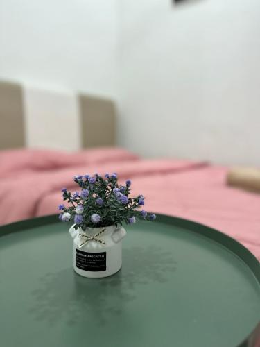 a vase filled with purple flowers sitting on a table at DeCherating privatepool in Cherating