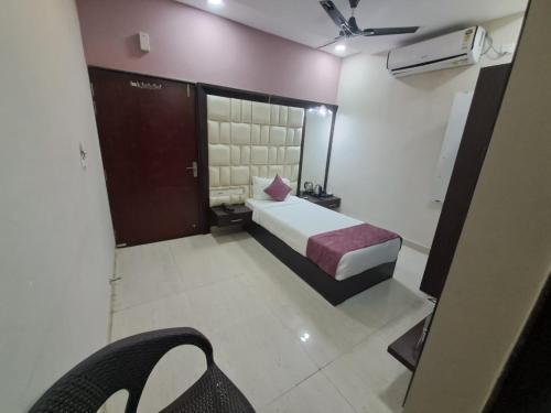 a hotel room with a bed and a room with at Bajaj's Karwan Inn in Jagdalpur