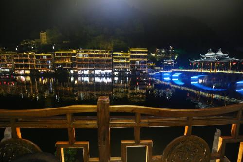 a view of the marina at night at LQJ Riverside Guest House in Fenghuang