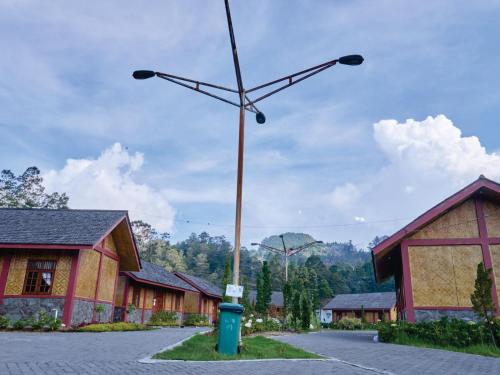 a pole with two lights on it next to a building at Taman Syailendra Cottage Dieng in Dieng