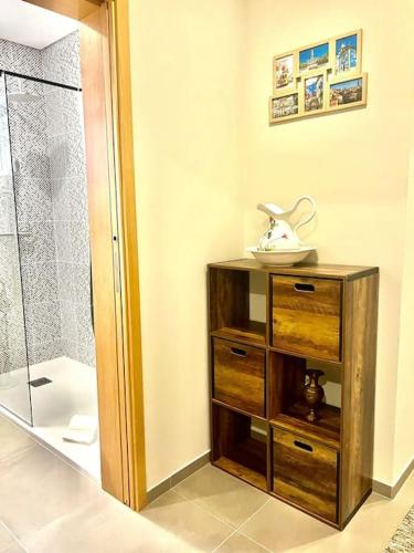 a bathroom with a shower and a wooden dresser at Pergola House - Typical Porto House in Porto