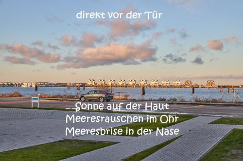 a car parked on a road with a bridge in the background at Hafensuite iPURA VIDA! - für Leben-Genießer in Kappeln