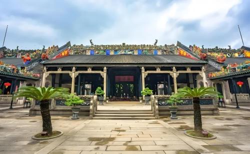 a building with palm trees in front of it at Lan Wan Hotel - Next to Huangsha Metro St ation -One cup of Free Cockt ail or Harbin Beer Per Room--Cha rgeable Airport Pick-up Service in Guangzhou