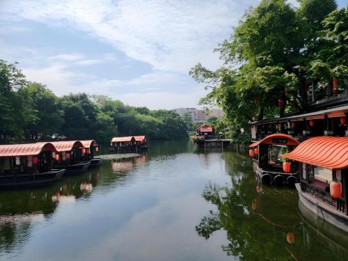 a river with several houses on the side of it at Lan Wan Hotel - Next to Huangsha Metro St ation -One cup of Free Cockt ail or Harbin Beer Per Room--Cha rgeable Airport Pick-up Service in Guangzhou