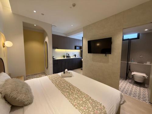 a bedroom with a large bed and a bathroom at ISA Hotel Amber Road in Singapore