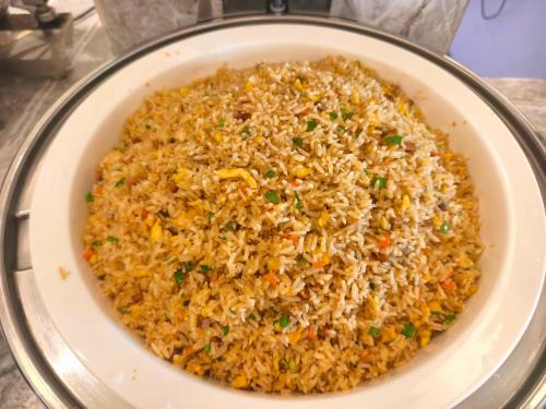 a bowl of fried rice on a table at MonMonBoutique Hotel in Thakho