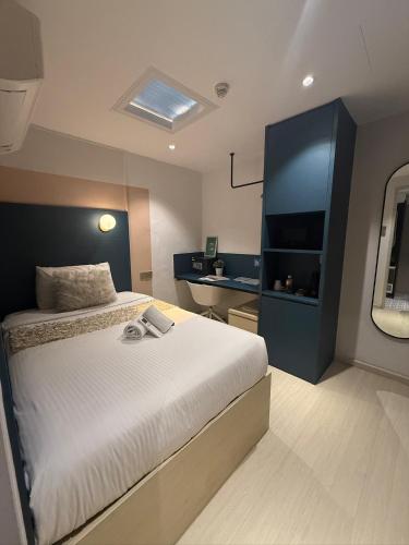a bedroom with a bed and a television in it at ISA Hotel Amber Road in Singapore