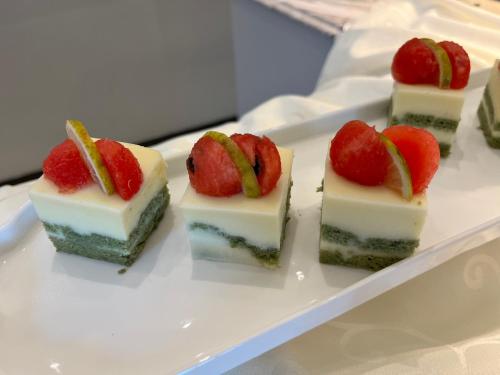 a white plate with four pieces of cake with strawberries on it at MonMonBoutique Hotel in Thakho