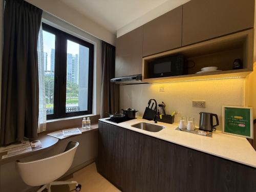 a kitchen with a sink and a counter top at ISA Hotel Amber Road in Singapore