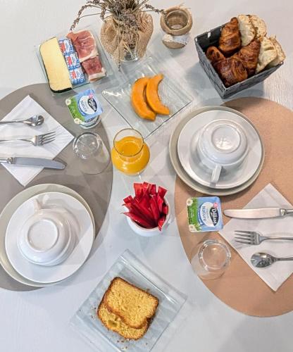 a table topped with plates of food and fruit at L'Aiguebelle in Céreste