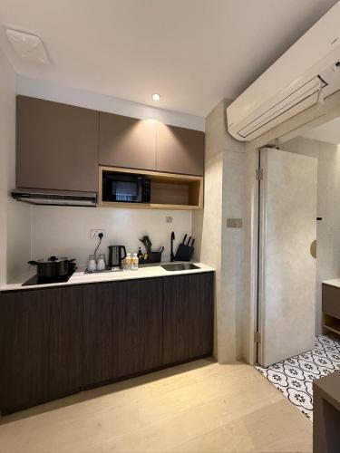 a kitchen with a sink and a counter top at ISA Hotel Amber Road in Singapore