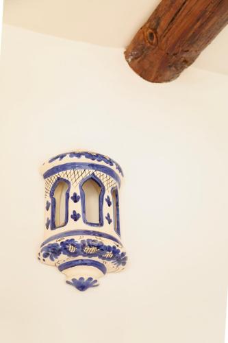 a blue and white vase hanging on a wall at Señorío de Ves in Casas de Ves