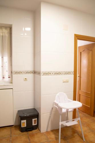 a white chair and a stool in a room at Señorío de Ves in Casas de Ves