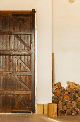an open door next to a pile of logs at Señorío de Ves in Casas de Ves