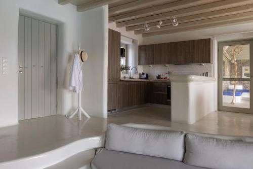 a living room with a bath tub and a kitchen at Villa Assa -Mykonos in Mýkonos City