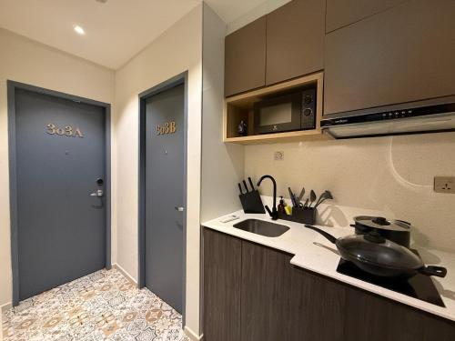a kitchen with a sink and a counter top at ISA Hotel Amber Road in Singapore