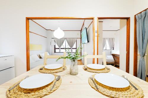 a dining room with a table with two chairs at Bohemian Tokyo in Tokyo