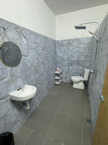 a bathroom with a sink and a toilet at Crystal Valley Jitra in Kampong Belukar
