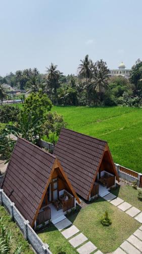 a small house with a brown roof at D' Rinjani View Bungalow in Masbagik