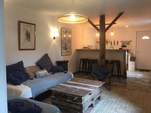 a living room with a couch and a table at VILLA HENRI in Flavy-le-Martel