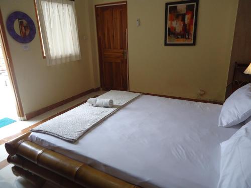 Ένα ή περισσότερα κρεβάτια σε δωμάτιο στο The Reinhold Guesthouse Bali