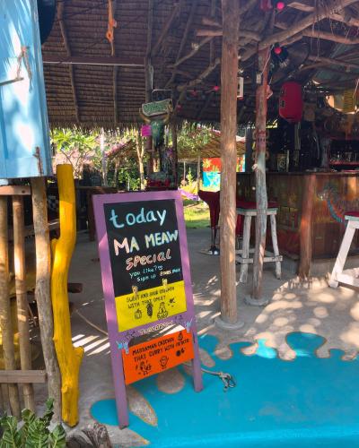 a sign in front of a restaurant with a menu at Freedom home in Ko Chang