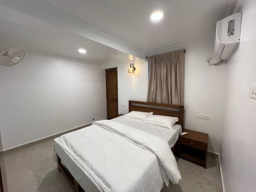 a bedroom with a bed and a tv in it at 1BHK AC Apartment 500m from Cavelossim Beach-Sussegado in Cavelossim