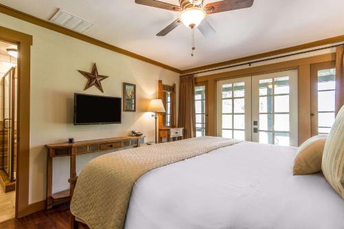 a bedroom with a bed and a flat screen tv at Sierra Sky Ranch in Oakhurst