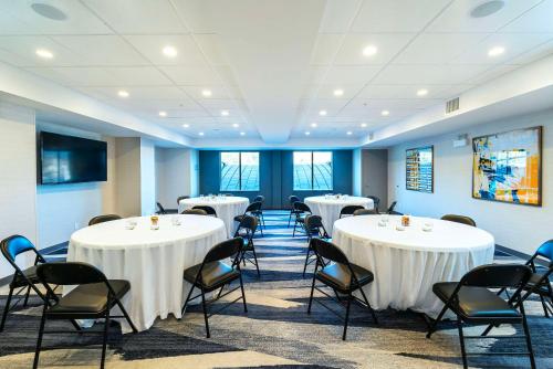 a conference room with white tables and chairs at Comfort Suites Kelowna in Kelowna