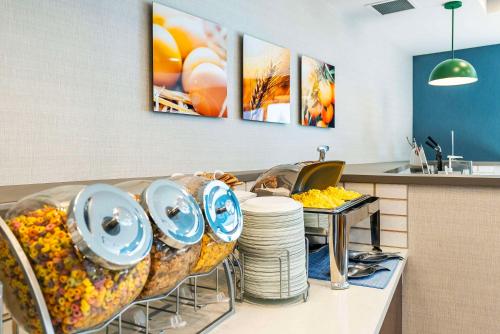 a kitchen with a table with plates and dishes at Comfort Suites Kelowna in Kelowna