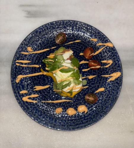 a plate of food with vegetables and nuts on it at Hotel Chipiona in Chipiona