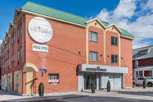 a brick building with a sign on the side of it at Les Suites Victoria, an Ascend Collection Hotel in Gatineau