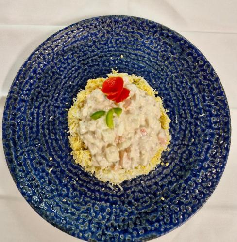 a plate of food with a red rose on it at Hotel Chipiona in Chipiona
