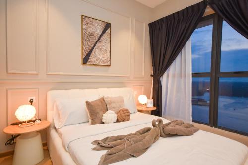a bedroom with a white bed and a window at Country Garden Seaview Suite by Nest Home at Danga Bay in Johor Bahru