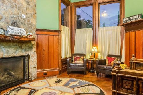 a living room with two chairs and a fireplace at Hotel Napa Valley, an Ascend Collection Hotel in Napa