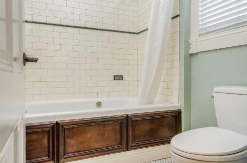 a bathroom with a bath tub and a toilet at Hotel Napa Valley, an Ascend Collection Hotel in Napa