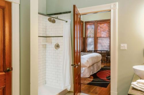 a bathroom with a shower and a bed in a room at Hotel Napa Valley, an Ascend Collection Hotel in Napa