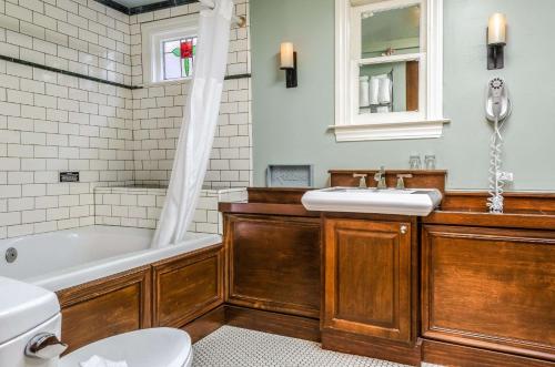 a bathroom with a tub and a sink and a toilet at Hotel Napa Valley, an Ascend Collection Hotel in Napa