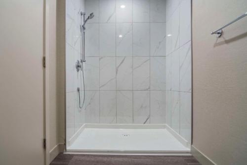 a bathroom with a shower with a glass door at The Hue Hotel, an Ascend Collection Hotel in Kamloops