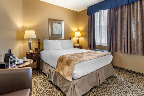 a hotel room with a large bed and a window at The Parlour Inn, an Ascend Collection Hotel in Stratford