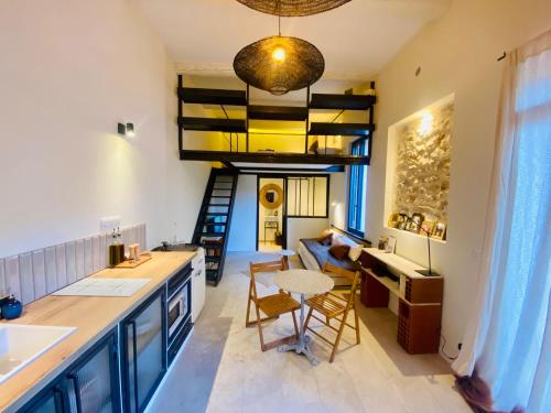 a kitchen and living room with a loft conversion at "La Forge" avec parking privé in Sète