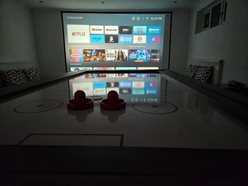 a room with a table with two red hearts on it at Annexe pool table air hockey table tennis movie in Windsor