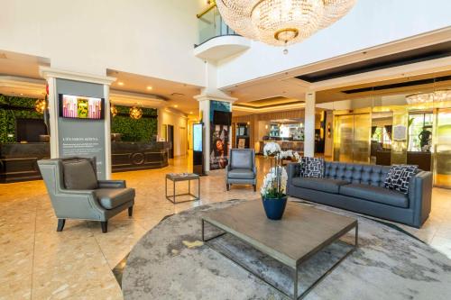 a lobby with a couch and two chairs and a table at Chateau Cartier Hotel & Resort, an Ascend Collection Resort in Gatineau
