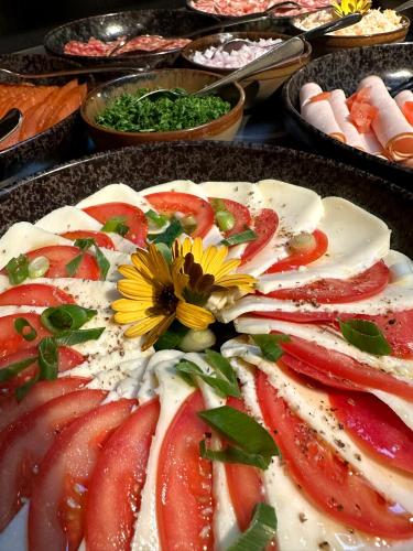 a plate of food with a flower on top at B&B Herenhuis in Izegem