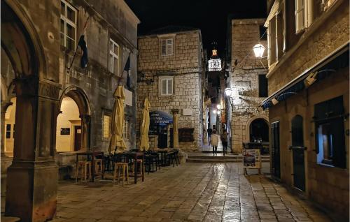 an empty street at night with tables and chairs at Nice Home In Prizba With Sauna in Prizba