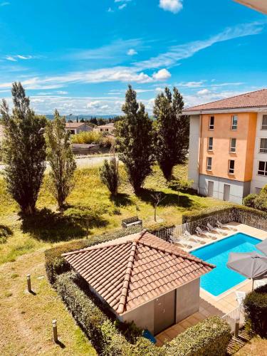 an aerial view of a house with a swimming pool at Comfort Aparthotel Carcassonne in Carcassonne