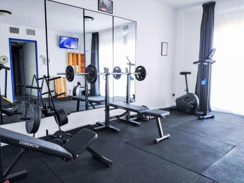 a gym with several machines and a mirror at Comfort Aparthotel Carcassonne in Carcassonne